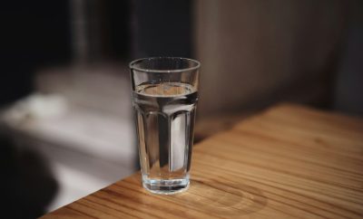A clear glass of water on a wooden table